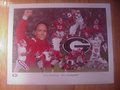Picture: David Pollack hand-signed Georgia Bulldogs 2002 SEC Champions limited edition print is also signed and numbered by artist Ken Modak. The autograph is absolutely guaranteed authentic and comes with a Certificate of Authenticity from us. This is Pollack's signature over his signature play at UGA-his defensive touchdown against South Carolina. Mark Richt, David Greene, Boss Bailey and many others from that magical team are also on this print.